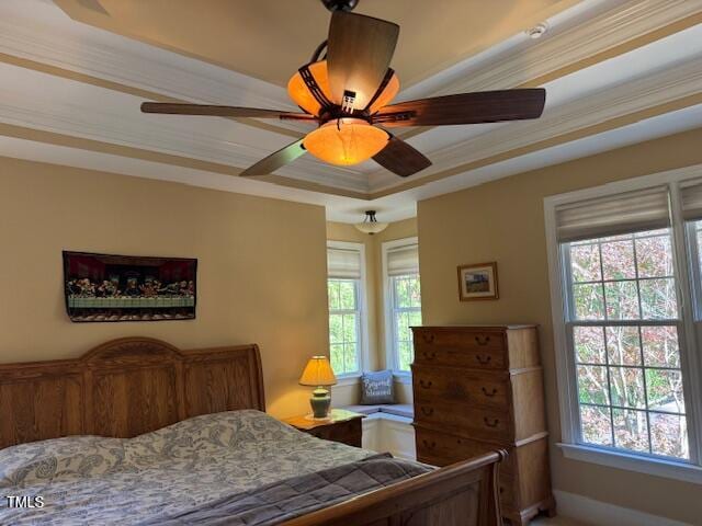 bedroom with ceiling fan, multiple windows, and ornamental molding