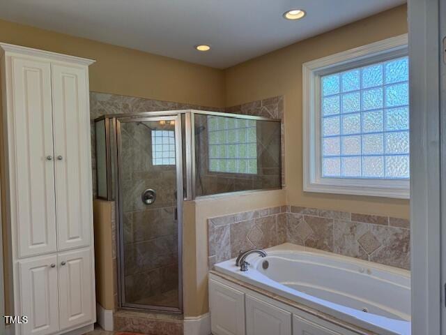 2012 Silverleaf Dr, Youngsville, NC 27596 - bathroom featuring healthy amount of natural light, a shower stall, a garden tub, and recessed lighting