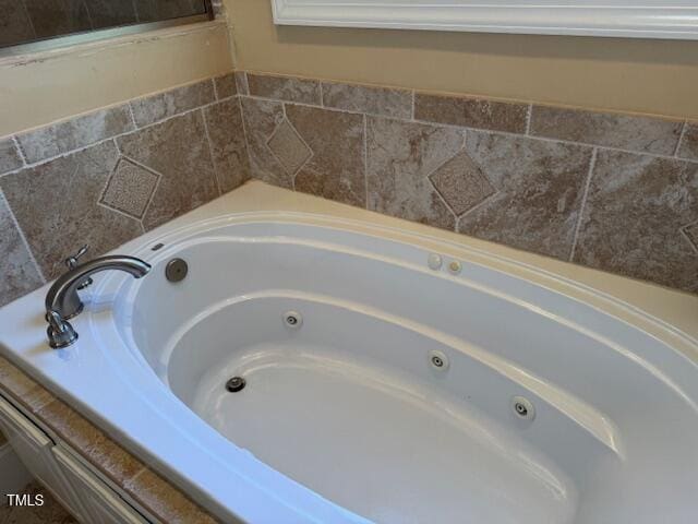 bathroom featuring tiled bath