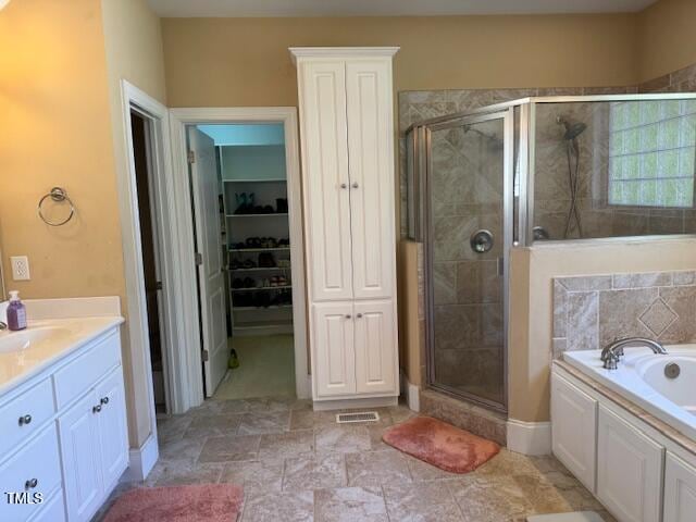 bathroom featuring independent shower and bath and vanity