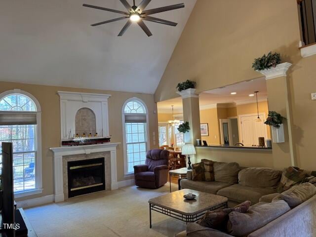 living room featuring high vaulted ceiling, a wealth of natural light, ceiling fan, and light colored carpet