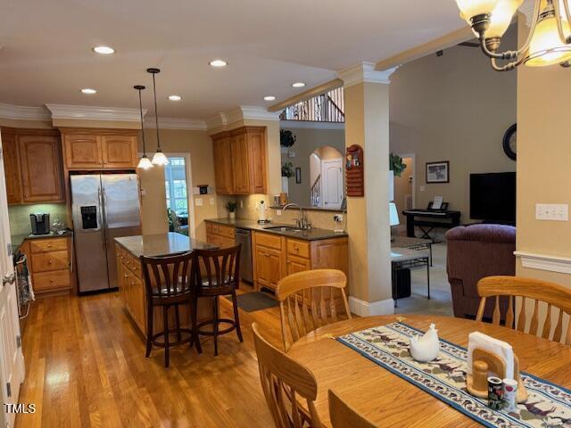 2012 Silverleaf Dr, Youngsville, NC 27596 - kitchen with stainless steel appliances, a sink, ornamental molding, a chandelier, and a center island