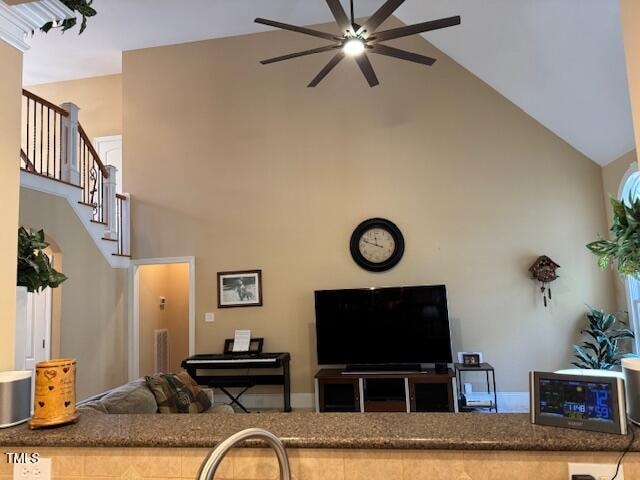 living room with ceiling fan and high vaulted ceiling