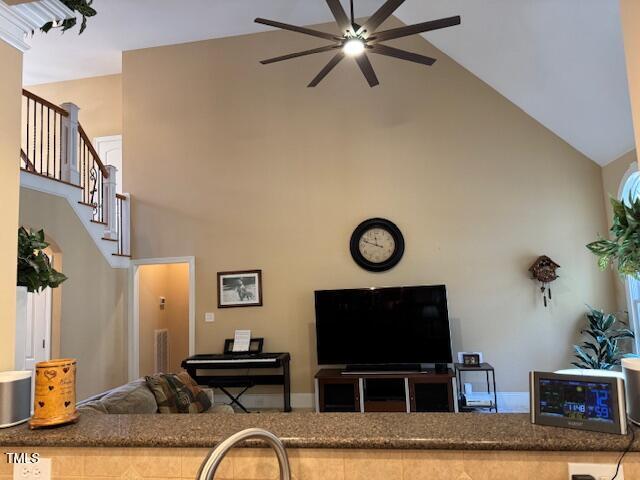 2012 Silverleaf Dr, Youngsville, NC 27596 - living room with high vaulted ceiling, ceiling fan, and stairs