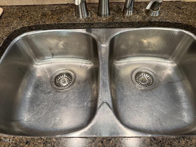 interior details with sink and dark stone countertops