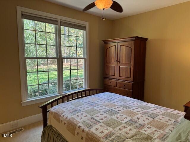 carpeted bedroom with ceiling fan