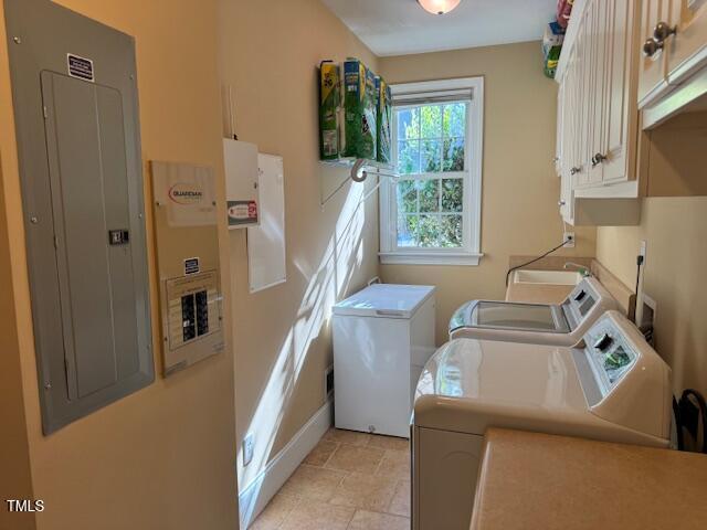 2012 Silverleaf Dr, Youngsville, NC 27596 - clothes washing area featuring independent washer and dryer, cabinet space, electric panel, baseboards, and light stone finish floors