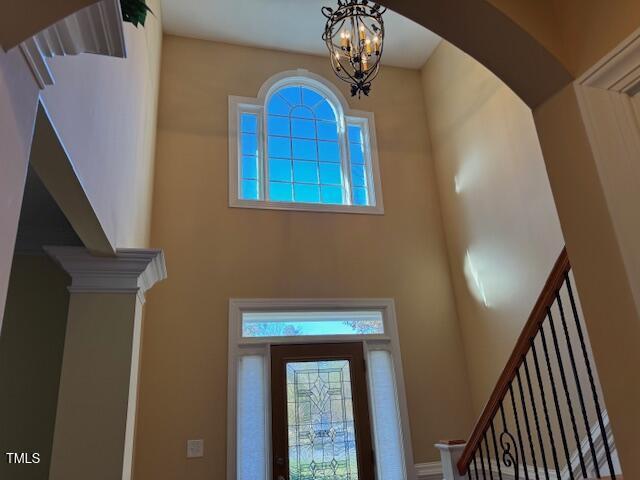2012 Silverleaf Dr, Youngsville, NC 27596 - foyer entrance featuring a high ceiling, arched walkways, stairs, plenty of natural light, and a chandelier