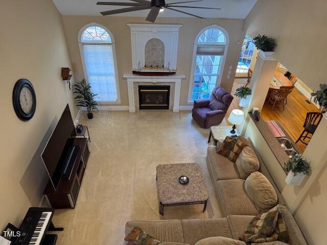 living room with light carpet and ceiling fan