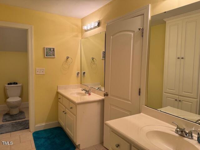 bathroom featuring toilet, vanity, and tile patterned floors