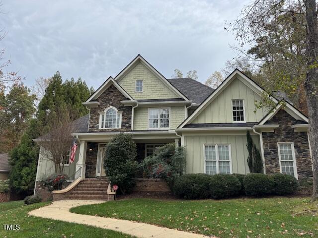 craftsman-style home with a front yard