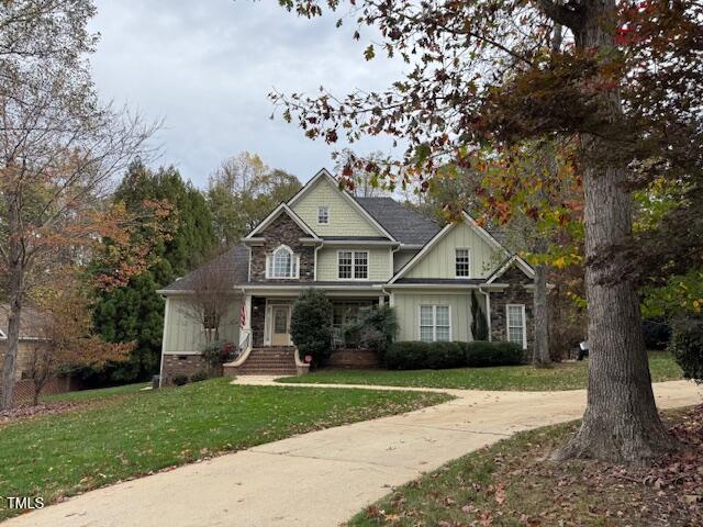 craftsman-style home featuring a front lawn