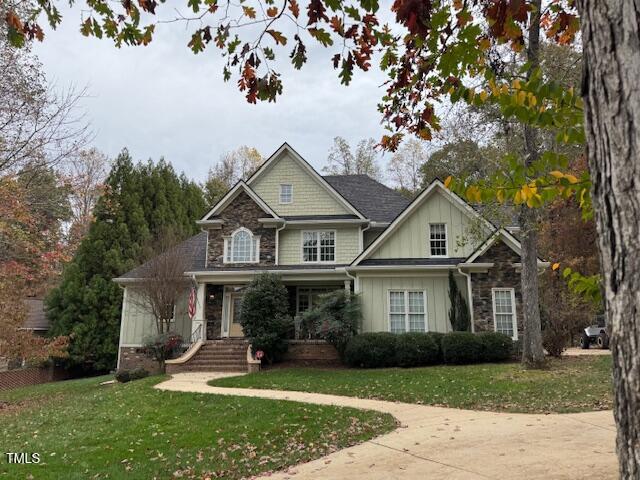 craftsman-style house with covered porch and a front yard