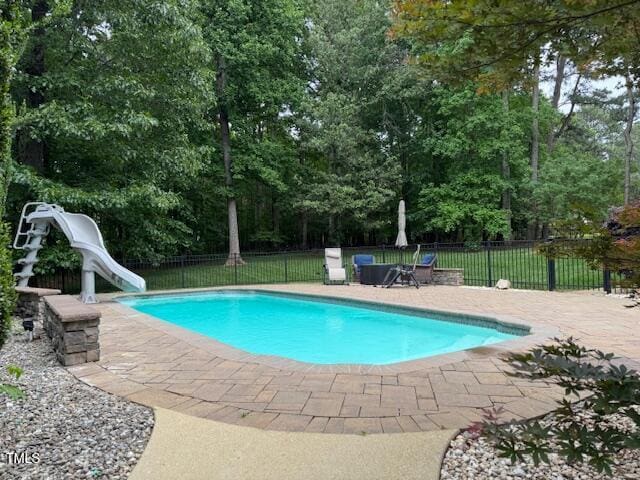 2012 Silverleaf Dr, Youngsville, NC 27596 - view of swimming pool with a water slide, fence, and a patio