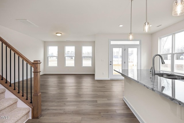 interior space featuring sink, dark wood-type flooring, and a wealth of natural light