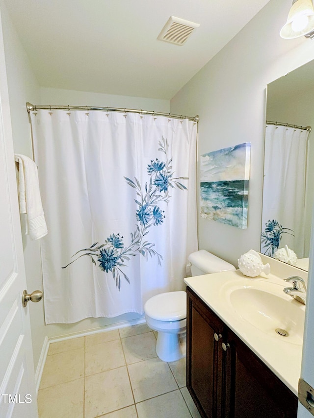 full bathroom with tile patterned floors, shower / bath combo with shower curtain, vanity, and toilet