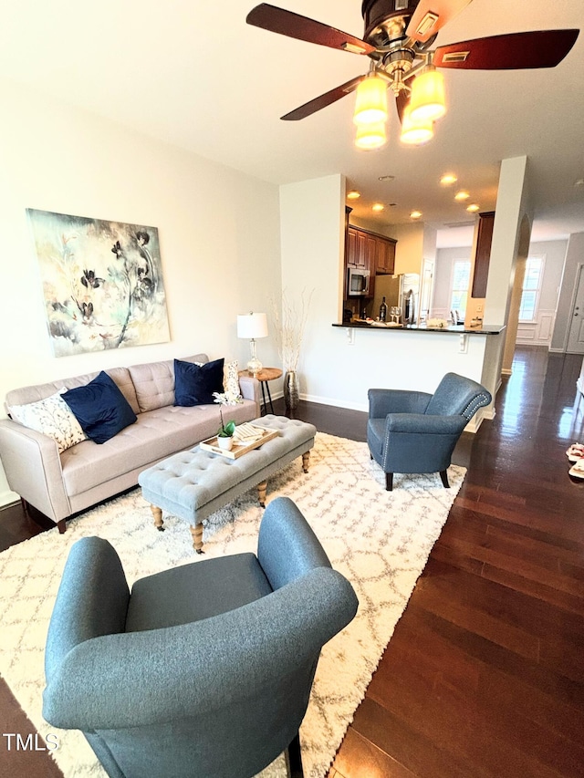 living room with hardwood / wood-style flooring and ceiling fan