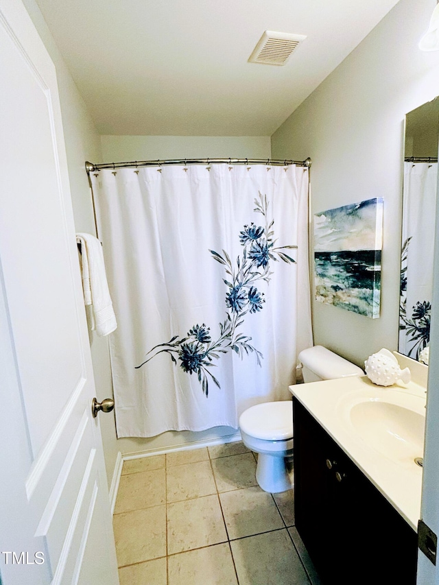 full bathroom featuring toilet, vanity, tile patterned floors, and shower / bath combo with shower curtain