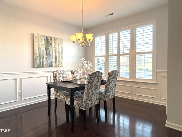 dining room with a chandelier and dark wood-type flooring