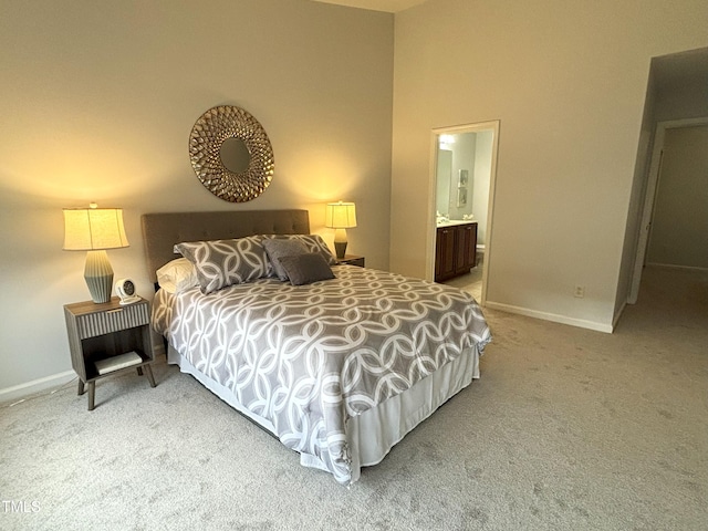 carpeted bedroom with ensuite bath