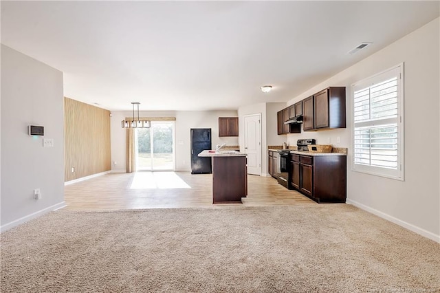 5918 Lowgrass Rd, Stedman, NC 28391 - kitchen with electric range, light colored carpet, open floor plan, dark brown cabinetry, and under cabinet range hood