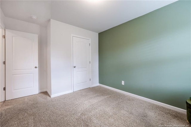 unfurnished bedroom featuring carpet and a closet