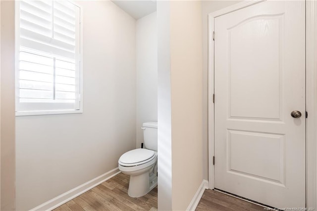 bathroom featuring hardwood / wood-style floors and toilet