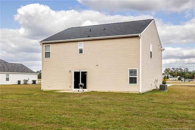 back of house with cooling unit and a lawn