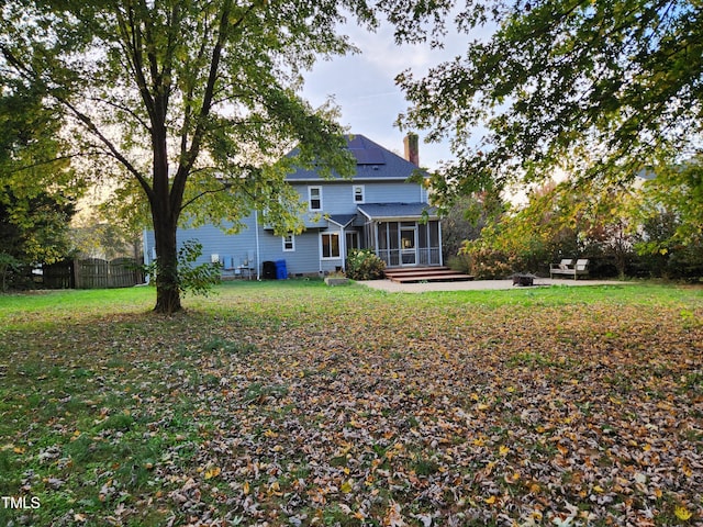 view of yard featuring a patio and a sunroom