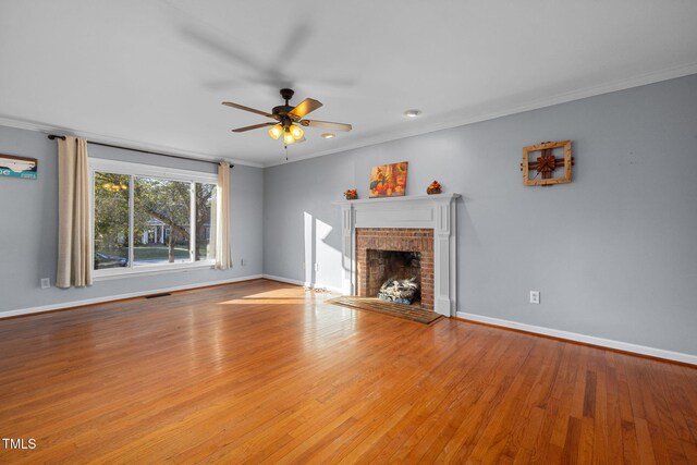 unfurnished living room featuring a fireplace, crown molding, and light hardwood / wood-style flooring