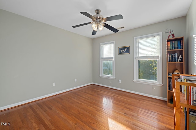 spare room featuring ceiling fan and light hardwood / wood-style floors