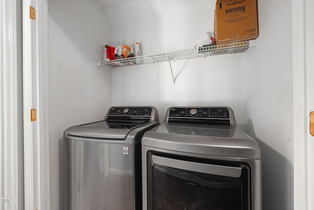 clothes washing area with washer and clothes dryer