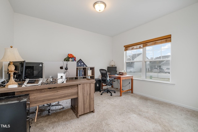 office area with light carpet and baseboards