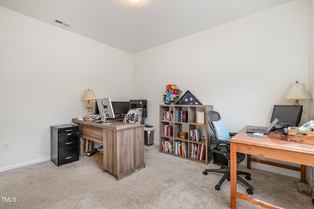 carpeted home office featuring visible vents and baseboards