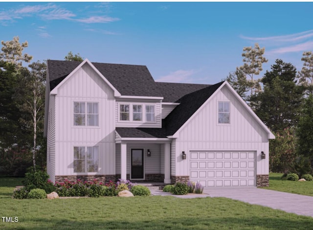 view of front of property featuring a garage and a front lawn