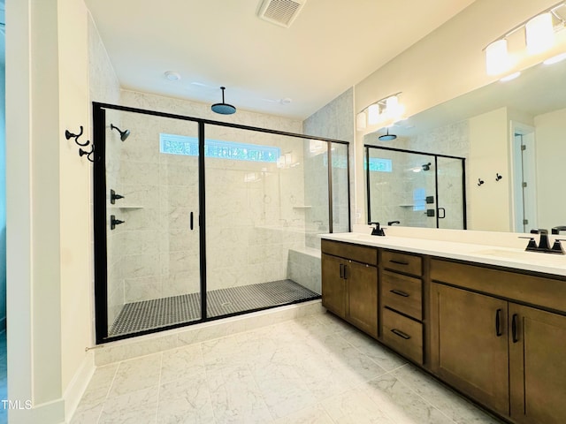 bathroom with vanity and a shower with shower door