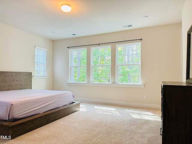 bedroom featuring light colored carpet