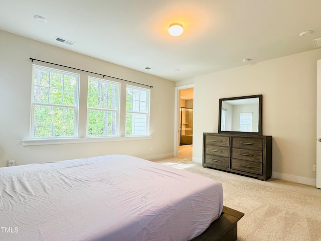 carpeted bedroom featuring ensuite bathroom