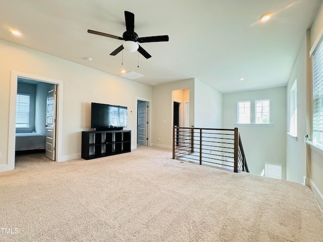 unfurnished living room with ceiling fan and light carpet