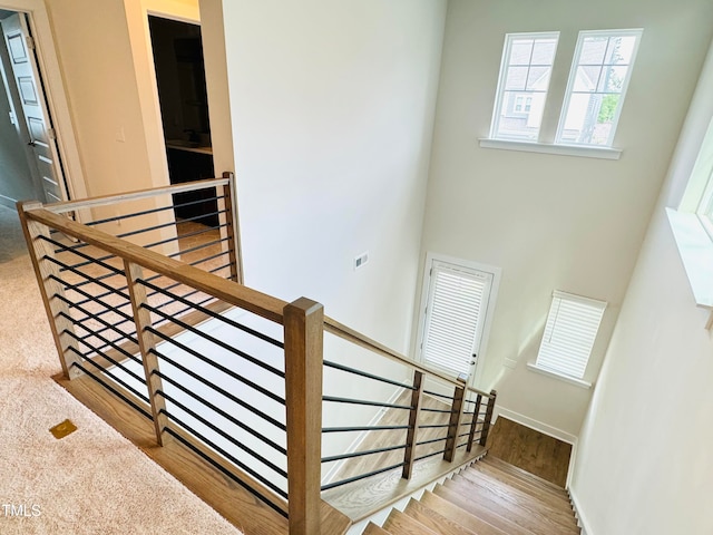 stairs with wood-type flooring