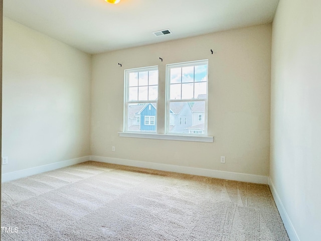 unfurnished room with light colored carpet