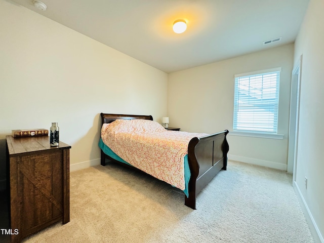 bedroom featuring light colored carpet