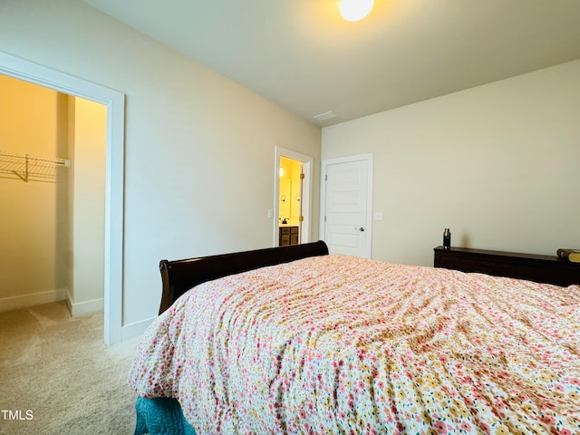 bedroom featuring a closet, carpet, and a spacious closet