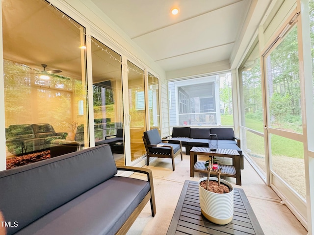 sunroom / solarium featuring plenty of natural light and ceiling fan