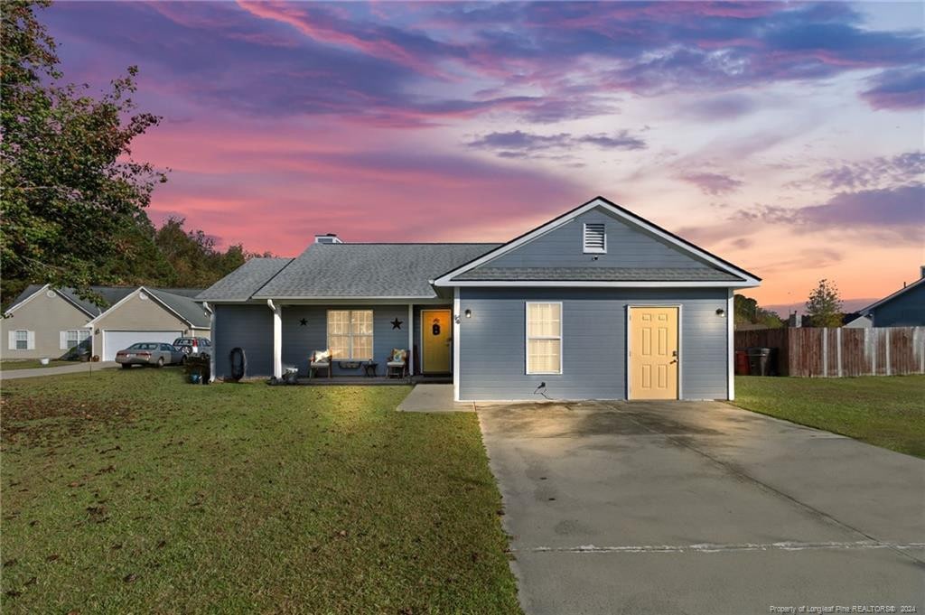 ranch-style house featuring a yard