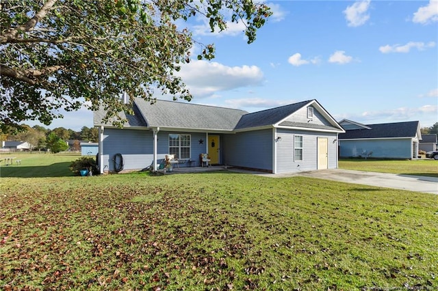 single story home featuring a front lawn and a garage