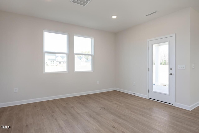 spare room featuring light hardwood / wood-style flooring