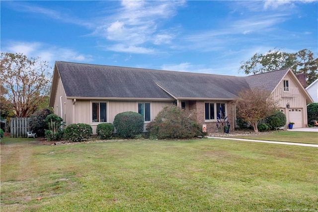 single story home featuring a front lawn and a garage