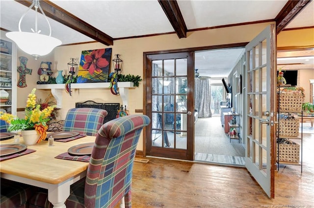 dining space featuring french doors, beamed ceiling, and hardwood / wood-style floors