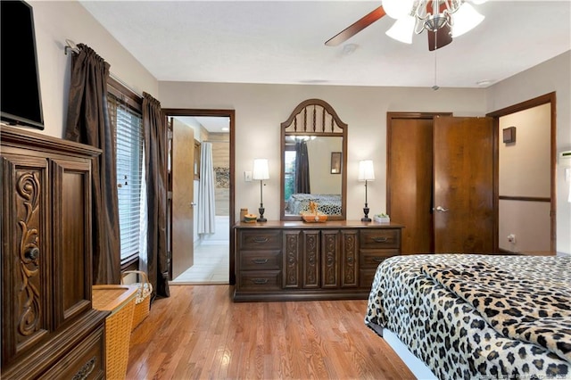 bedroom with ceiling fan, light wood-type flooring, and multiple windows